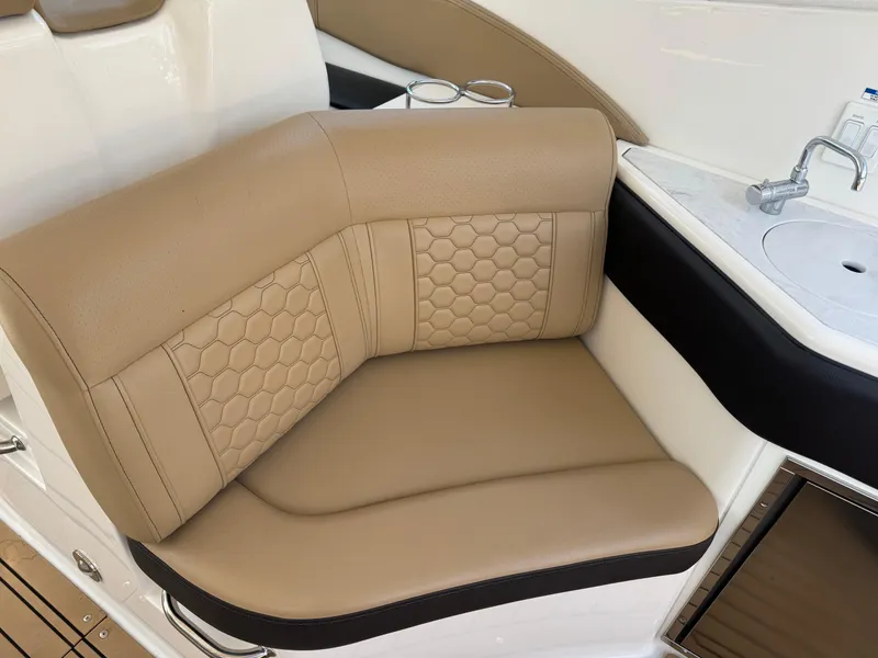 Slide: The Image of Luxurious tan seating on 2021 Sea Ray Sundancer 320 Coupe Outboard boat interior. - 18