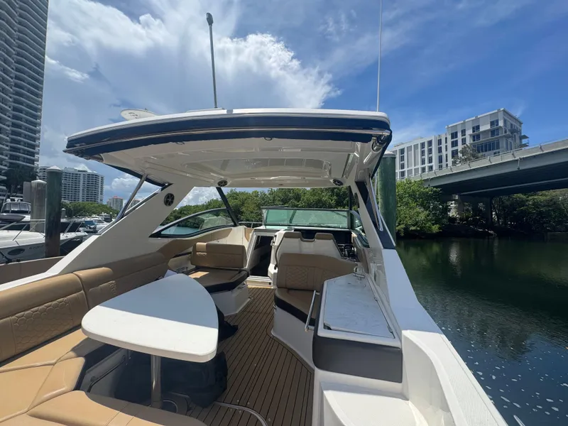 Slide: The Image of 2021 Sea Ray Sundancer 320 Coupe Outboard docked, featuring spacious seating and sleek design. - 26