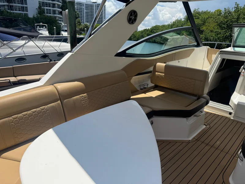 Slide: The Image of 2021 Sea Ray Sundancer 320 Coupe Outboard interior with tan seating and sleek design. - 29