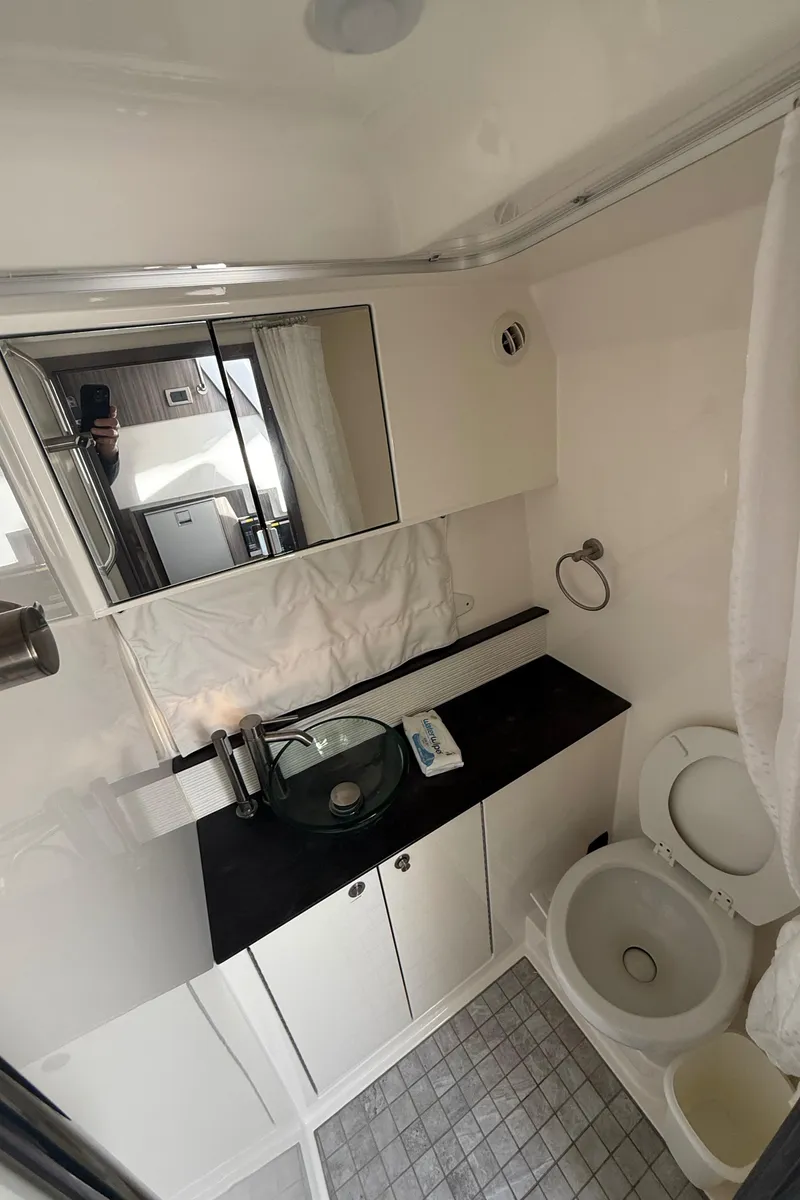 Slide: The Image of 2021 Sea Ray Sundancer 320 Coupe OB bathroom with modern fixtures and sleek design. - 31