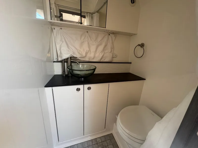 Slide: The Image of 2021 Sea Ray Sundancer 320 Coupe Outboard bathroom with modern sink and toilet. - 32