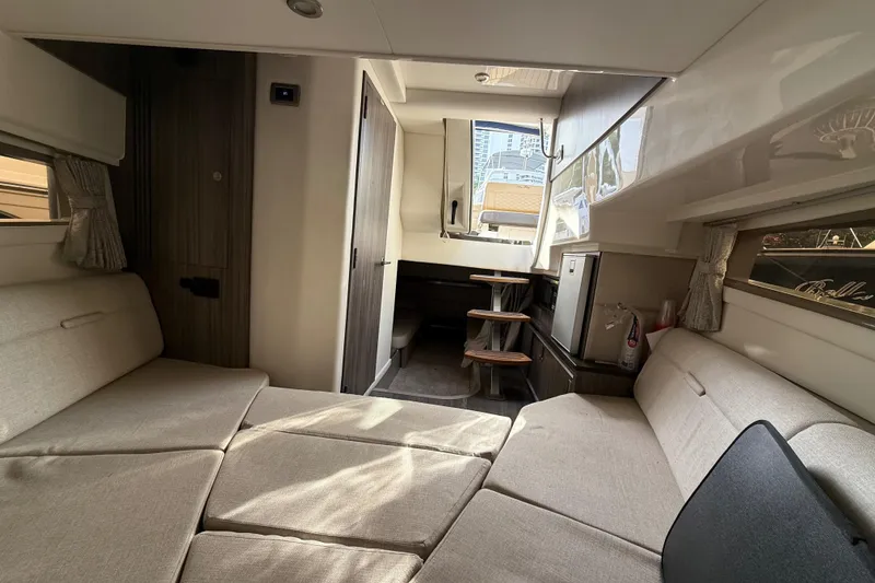 Slide: The Image of Interior of 2021 Sea Ray Sundancer 320 Coupe OB, featuring cozy seating and modern design. - 35