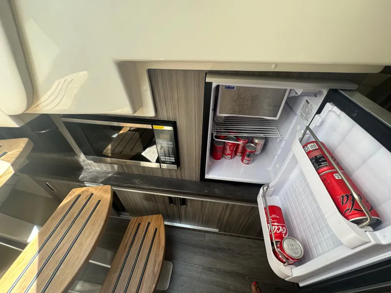 Slide: The Image of Interior of 2021 Sea Ray Sundancer 320 Coupe with fridge and microwave. - 36