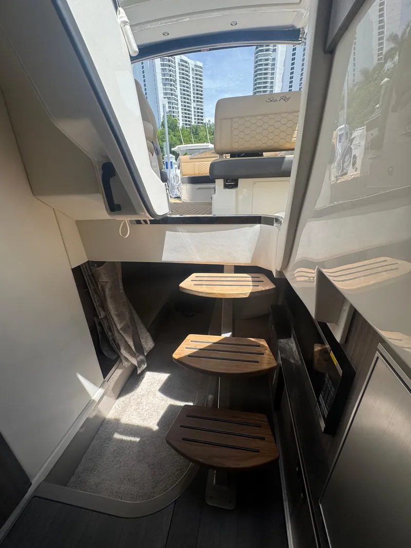 Slide: The Image of Interior view of 2021 Sea Ray Sundancer 320 Coupe Outboard with wooden steps and seating. - 38