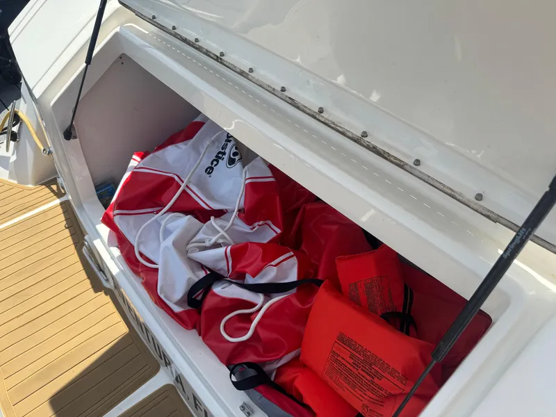 Slide: The Image of Storage compartment on 2021 Sea Ray Sundancer 320 Coupe Outboard with life jackets and gear. - 39