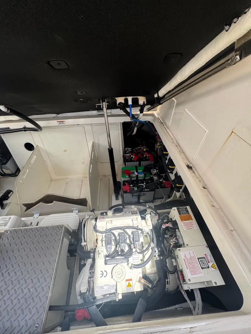 Slide: The Image of Engine compartment of 2021 Sea Ray Sundancer 320 Coupe Outboard, showcasing mechanical components. - 46