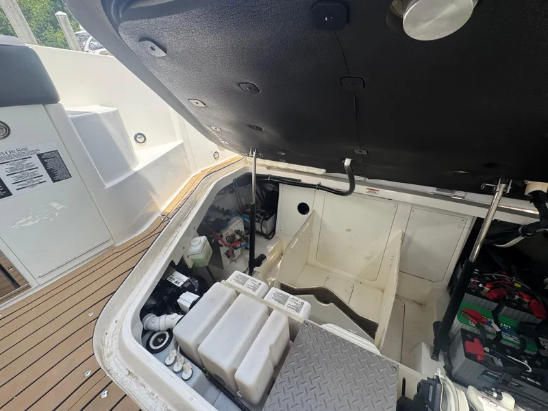 Slide: The Image of Open engine compartment of 2021 Sea Ray Sundancer 320 Coupe Outboard, showcasing internal components. - 48