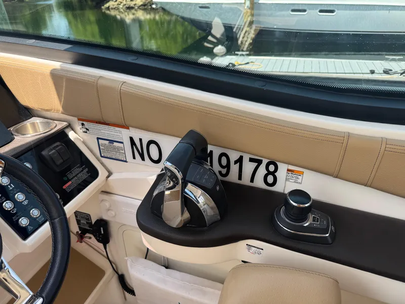 Slide: The Image of 2021 Sea Ray Sundancer 320 Coupe Outboard helm with controls and registration number. - 7