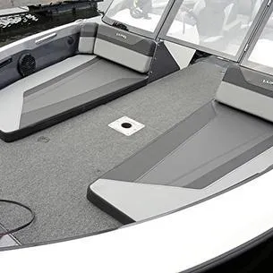 Slide: The Image of 2025 Lund 202 Pro-V GL boat interior with gray seating and carpeted deck. - 7