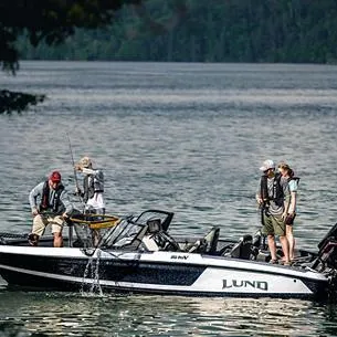 Slide: The Image of 2025 Lund 202 Pro-V GL boat on a lake with people fishing. - 8
