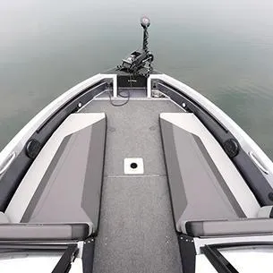 Slide: The Image of 2025 Lund 202 Pro-V GL boat interior with gray seating and carpeted floor. - 9