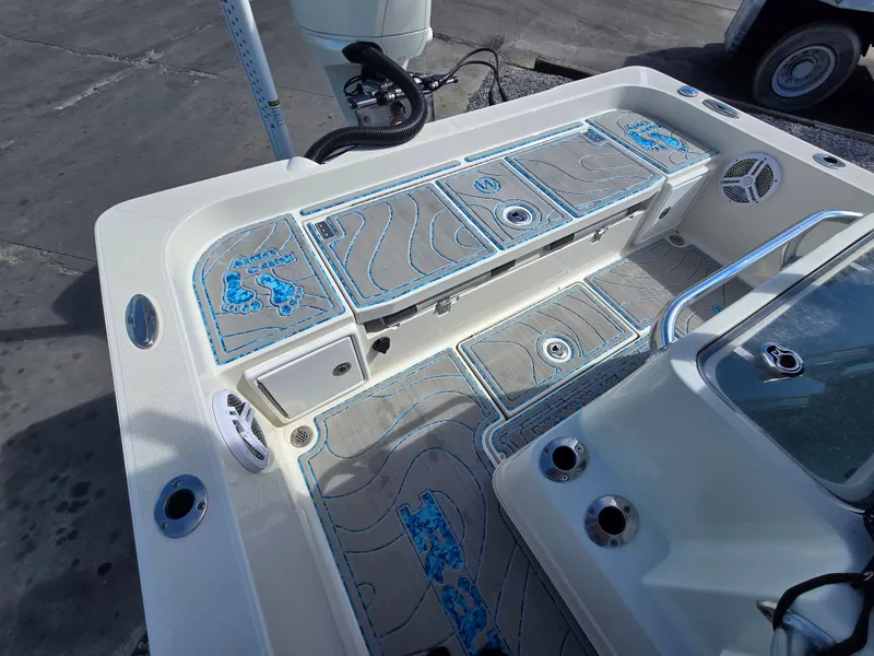 Slide: The Image of 2021 Ranger 2360 Bay boat deck with storage compartments and fishing rod holders. - 18