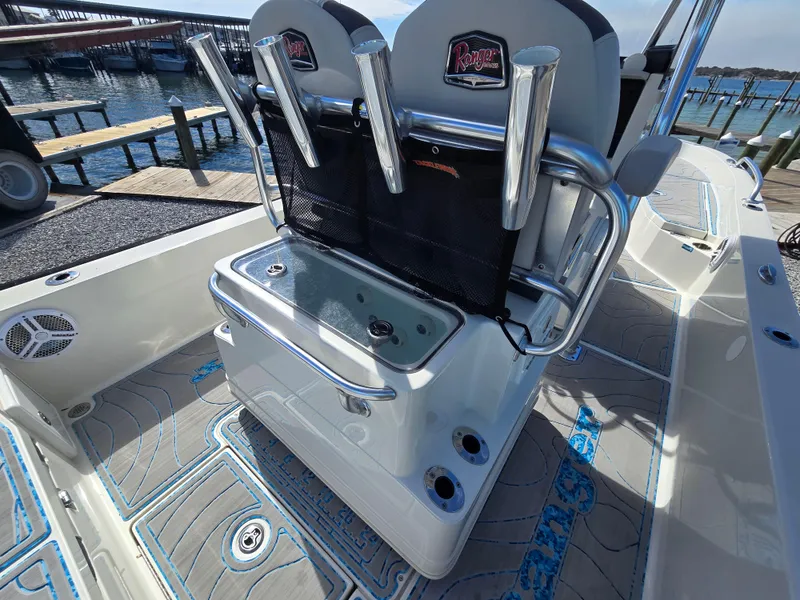 Slide: The Image of 2021 Ranger 2360 Bay boat interior with seating and storage, dockside view. - 19