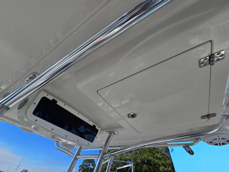 Slide: The Image of 2021 Ranger 2360 Bay boat ceiling with storage compartment and metal railings. - 21