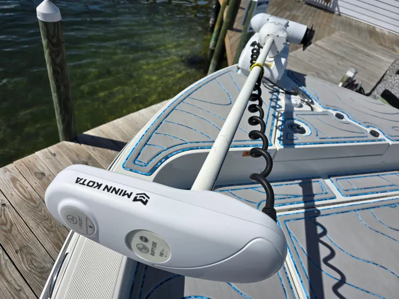 Slide: The Image of Minn Kota trolling motor on 2021 Ranger 2360 Bay boat docked by water. - 9