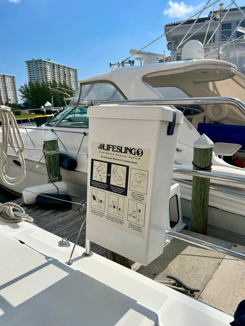 Slide: The Image of Lifesling3 on Lagoon 620 yacht, docked with other boats, sunny day, 2017 model. - 12