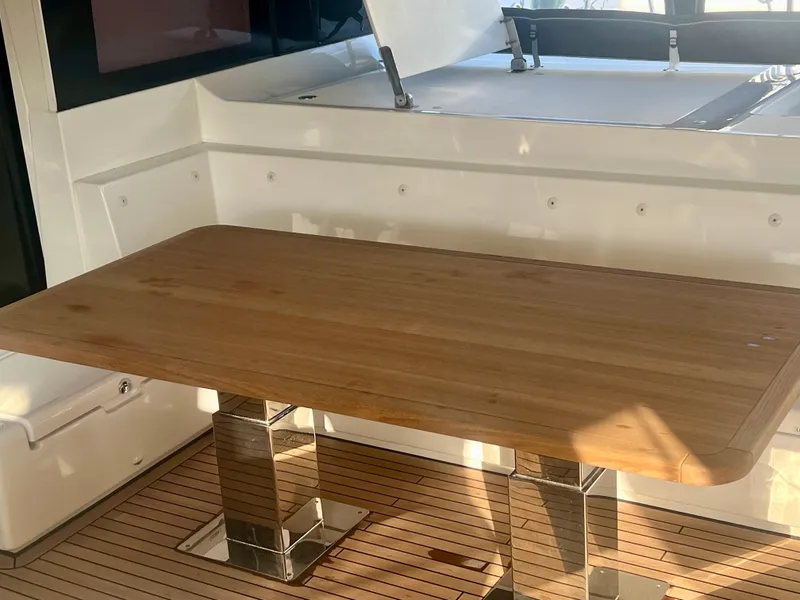 Slide: The Image of Luxurious wooden table on 2017 Lagoon 620 yacht deck, featuring sleek design and modern finishes. - 19