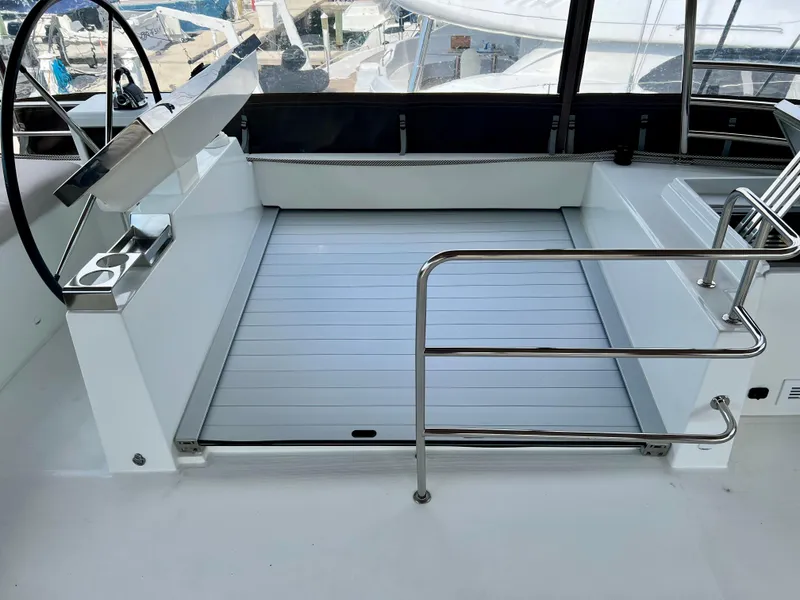 Slide: The Image of Helm station of 2017 Lagoon 620 catamaran with sleek design and stainless steel railings. - 32