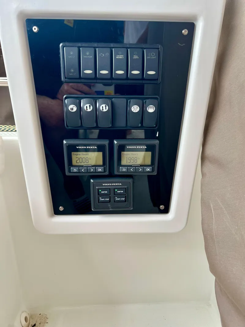 Slide: The Image of Control panel of a 2017 Lagoon 620 yacht with switches and digital displays. - 46