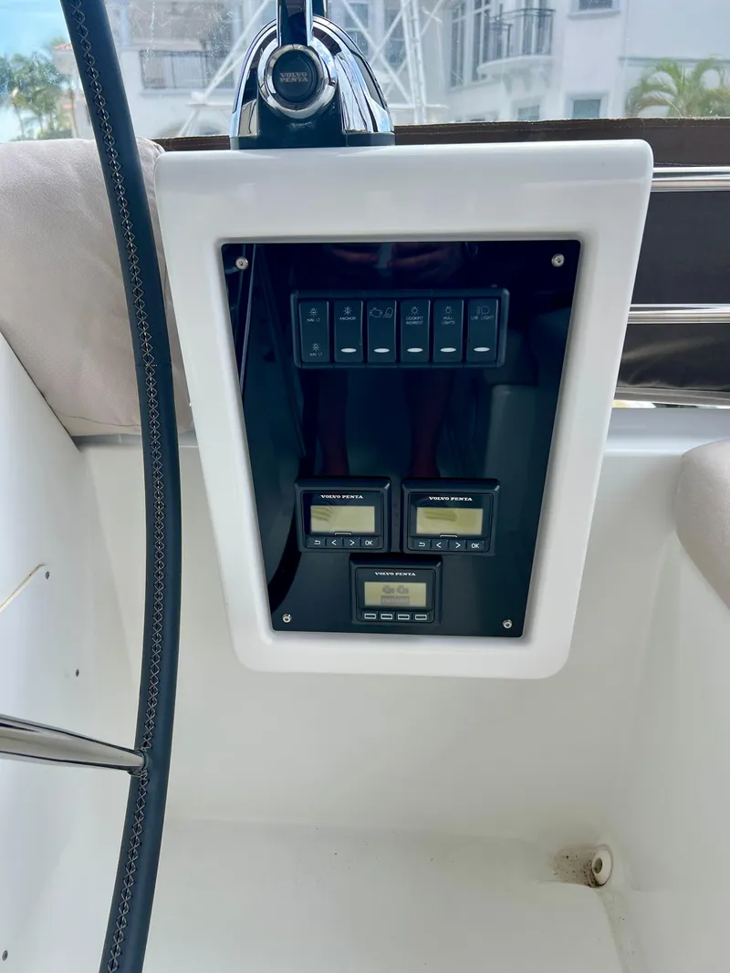 Slide: The Image of Control panel of a 2017 Lagoon 620 yacht with digital displays and switches. - 48