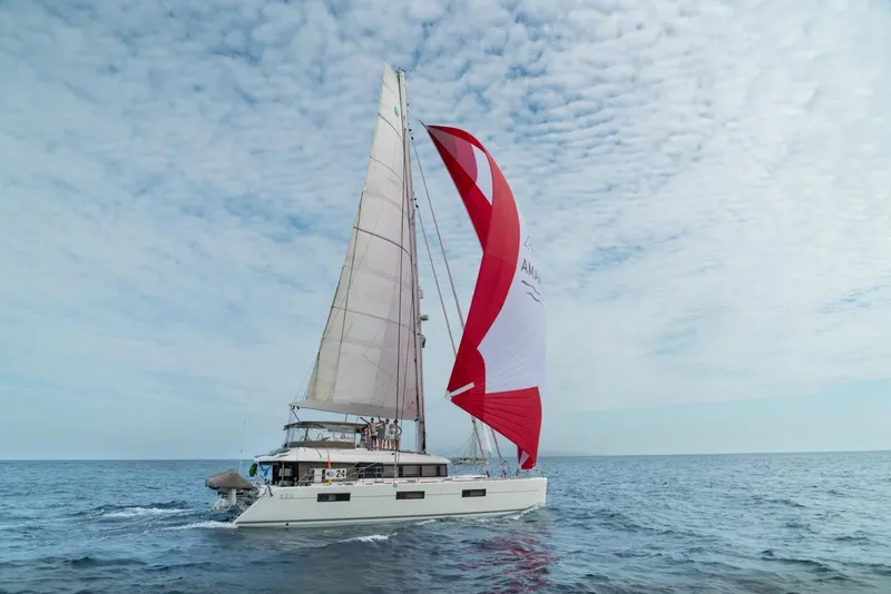 Slide: The Image of 2017 Lagoon 620 catamaran sailing on open sea under cloudy sky. - 8