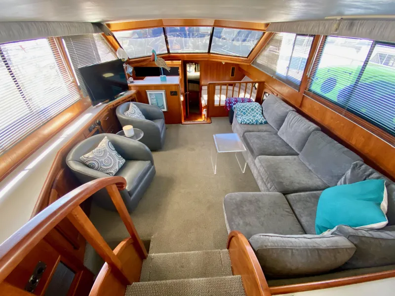 Slide: The Image of 1988 Californian Sundeck Motoryacht interior with cozy seating and panoramic windows. - 13