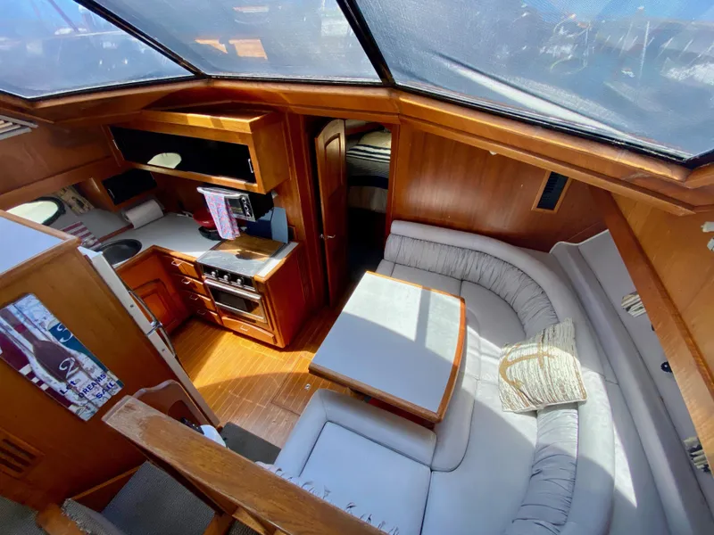 Slide: The Image of Interior of 1988 Californian Sundeck Motoryacht with cozy seating and kitchen area. - 20
