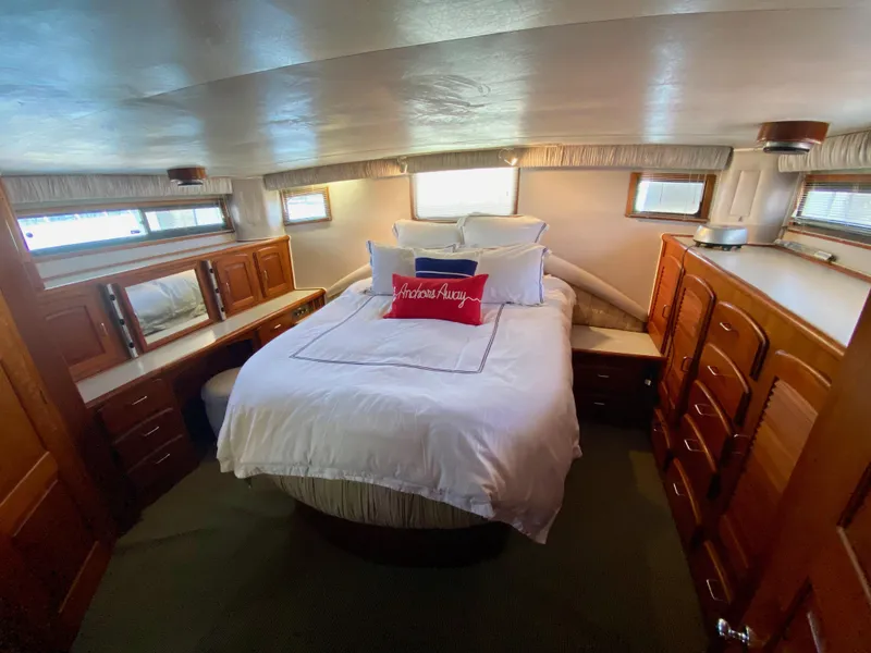 Slide: The Image of 1988 Californian Sundeck Motoryacht bedroom with cozy bed and wooden cabinetry. - 25