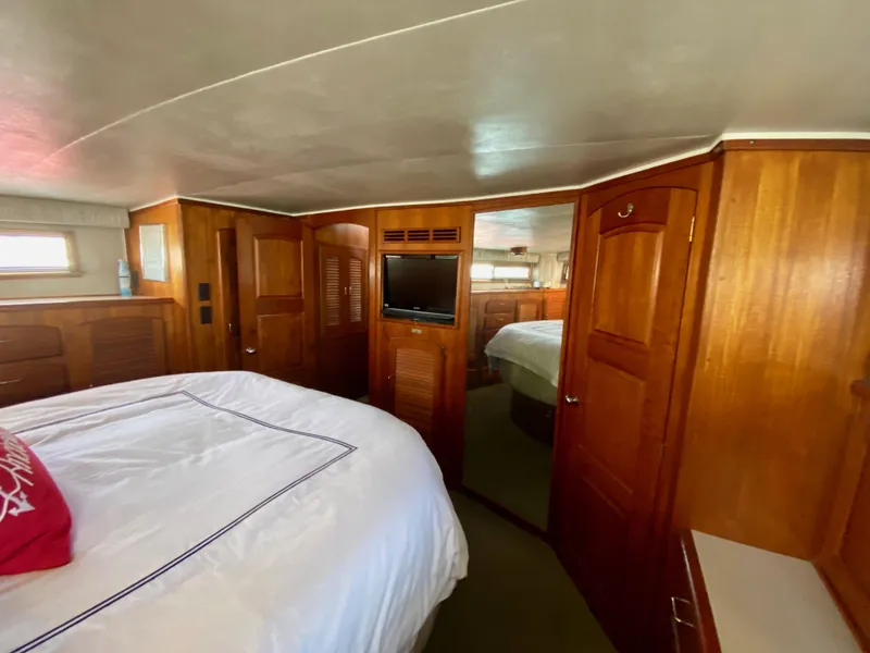 Slide: The Image of 1988 Californian Sundeck Motoryacht bedroom with wooden interior and cozy bed. - 26