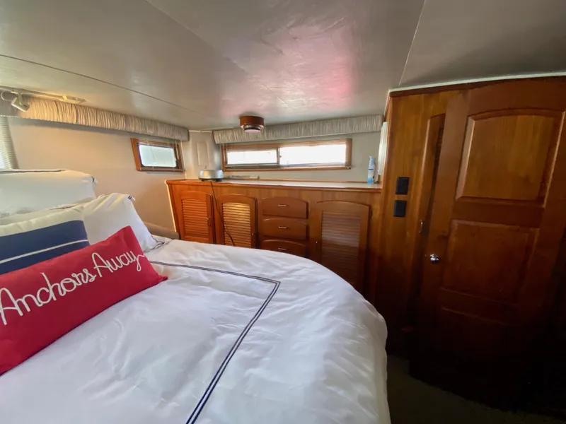 Slide: The Image of 1988 Californian Sundeck Motoryacht bedroom with wooden cabinetry and nautical-themed decor. - 28