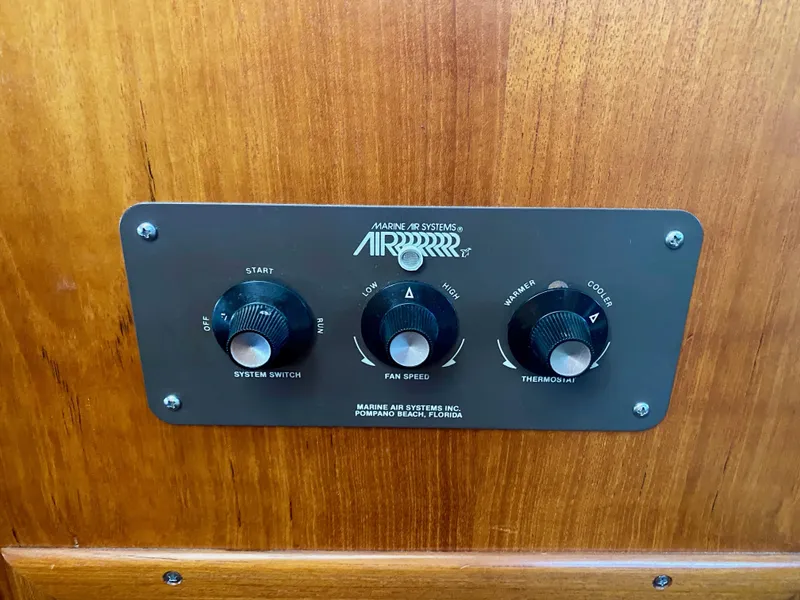 Slide: The Image of Control panel of 1988 Californian Sundeck Motoryacht, featuring system switch, fan speed, and thermostat. - 35