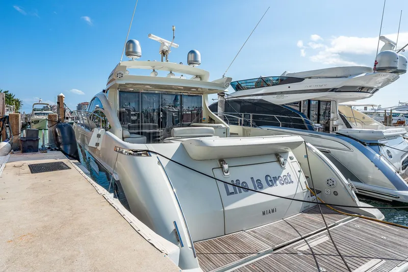 Slide: The Image of 2007 Azimut 62S luxury yacht docked at marina under clear blue sky. - 18