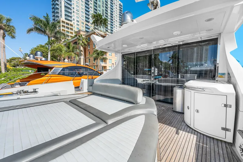 Slide: The Image of 2007 Azimut 62S yacht with spacious deck, modern design, and cityscape backdrop. - 22