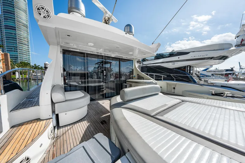 Slide: The Image of Luxury 2007 Azimut 62S yacht with spacious deck and modern design in marina setting. - 23