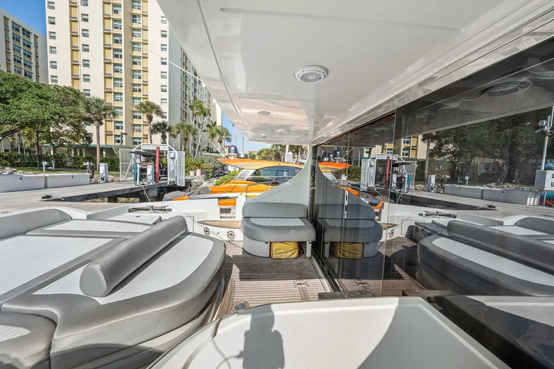 Slide: The Image of 2007 Azimut 62S yacht with sleek seating and modern design at a marina. - 25