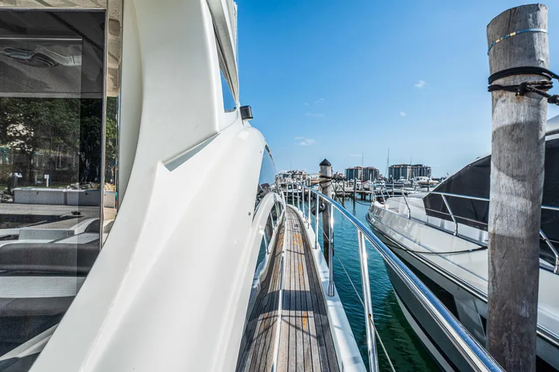 Slide: The Image of 2007 Azimut 62S yacht docked at a marina, showcasing sleek design and luxury features. - 26