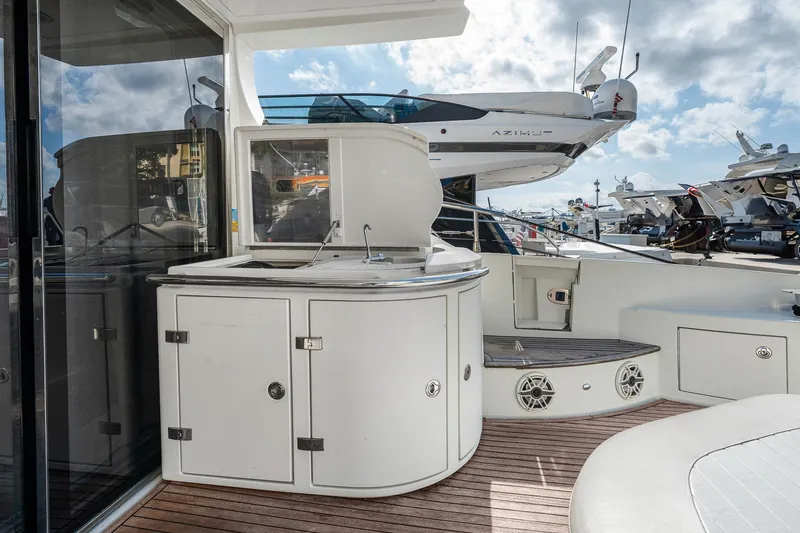 Slide: The Image of Outdoor kitchen area on a 2007 Azimut 62S yacht, featuring sleek cabinetry and a sink. - 30