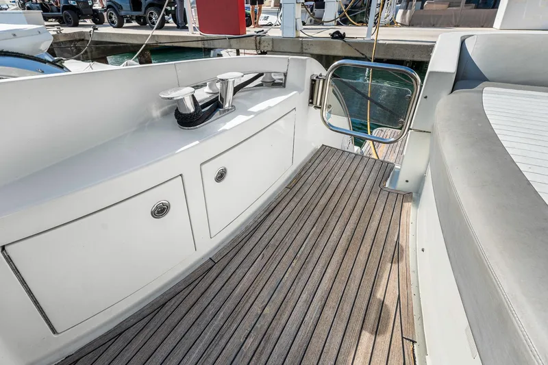 Slide: The Image of 2007 Azimut 62S yacht deck with teak flooring and storage compartments. - 31