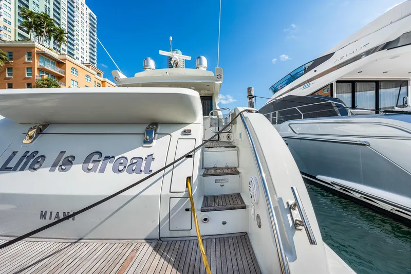 Slide: The Image of 2007 Azimut 62S yacht docked, featuring "Life Is Great" text, Miami backdrop. - 32