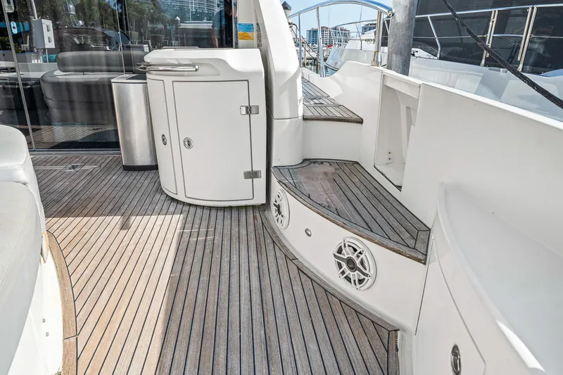 Slide: The Image of 2007 Azimut 62S yacht deck with wooden flooring and sleek white cabinetry. - 34