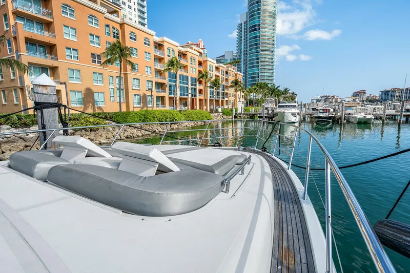 Slide: The Image of 2007 Azimut 62S yacht docked in a marina with luxury waterfront buildings. - 36