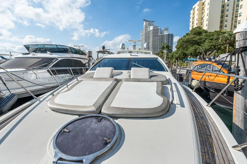 Slide: The Image of 2007 Azimut 62S yacht docked, featuring sun loungers and sleek design. - 41