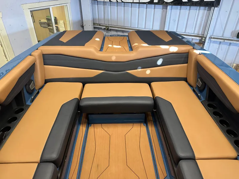 Slide: The Image of 2025 Axis A245 boat interior with tan and black seating, showcasing modern design. - 4