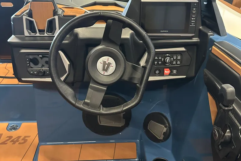 Slide: The Image of 2025 Axis A245 boat dashboard with steering wheel and control panel. - 9