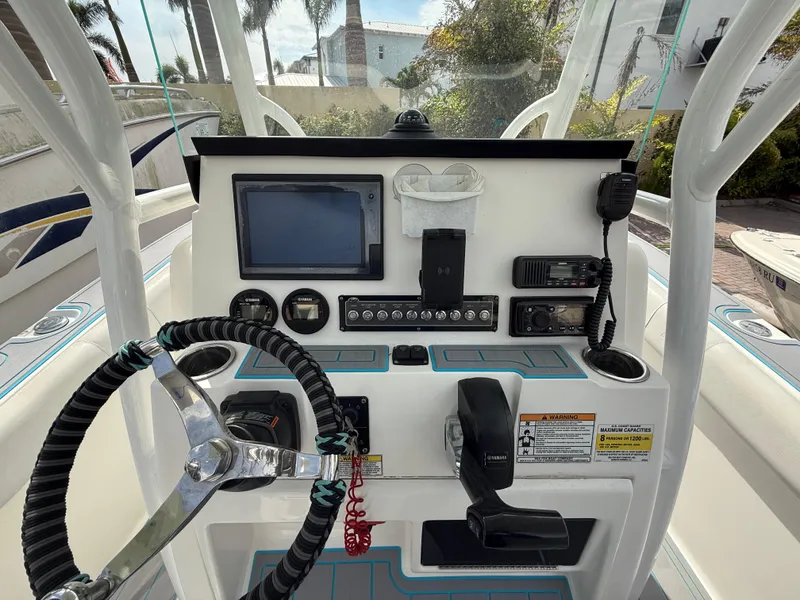 Slide: The Image of 2019 Sea Fox 228 Commander dashboard with steering wheel, controls, and navigation equipment. - 10
