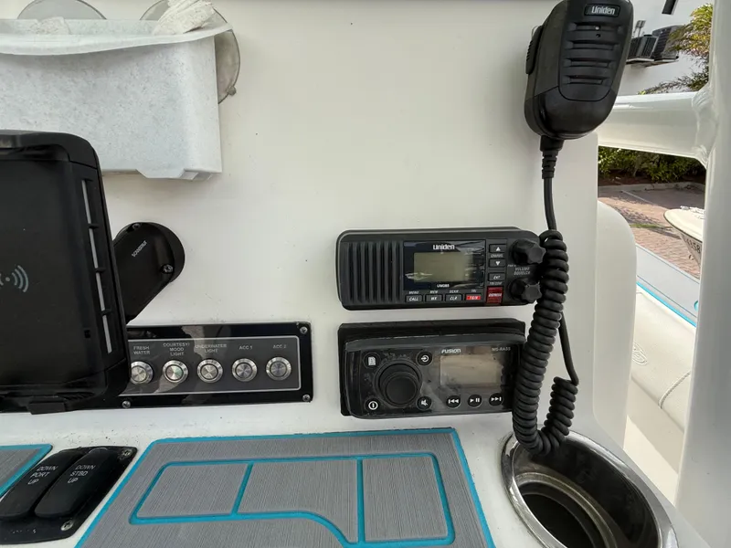 Slide: The Image of Control panel of a 2019 Sea Fox 228 Commander boat with radio and switches. - 13