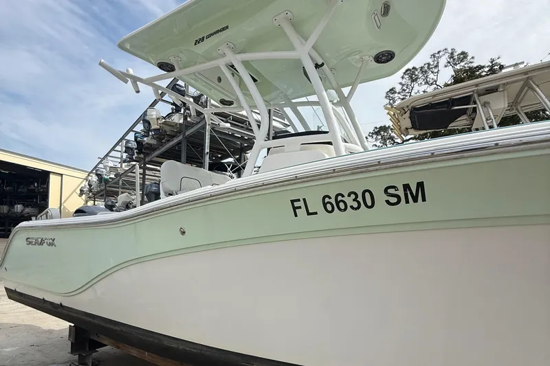 Slide: The Image of 2019 Sea Fox 228 Commander boat with registration FL 6630 SM, docked outdoors. - 2