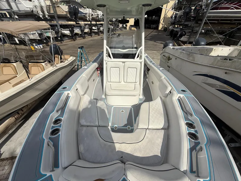 Slide: The Image of 2019 Sea Fox 228 Commander boat interior with seating and console, docked among other boats. - 21
