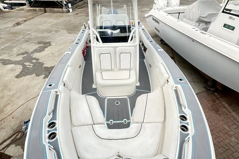 Slide: The Image of 2019 Sea Fox 228 Commander boat interior with white seating and console, docked outdoors. - 22
