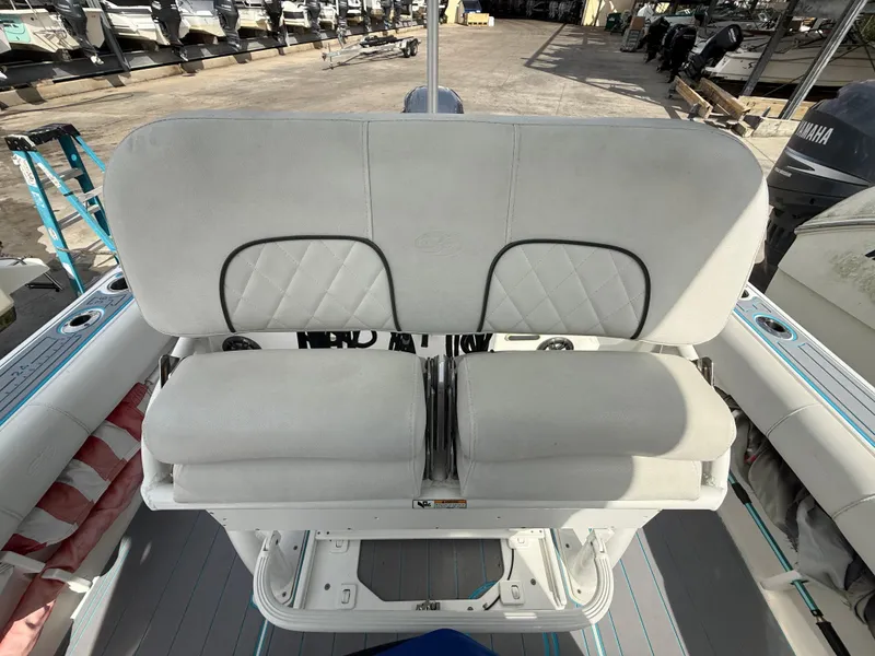 Slide: The Image of 2019 Sea Fox 228 Commander boat seating with cushioned backrest and storage. - 26